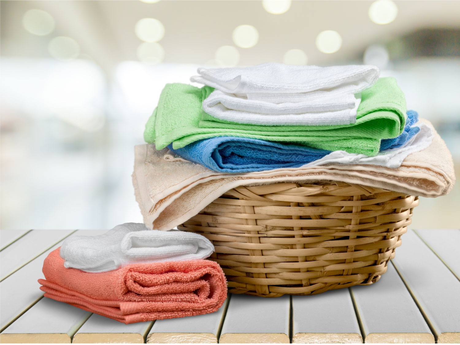 wicker laundry basket with clean towels